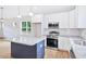 Modern kitchen featuring stainless steel appliances, gray countertops, white cabinets, and pendant lights at 0 Cedar Grove Church Rd Rd, Roxboro, NC 27574