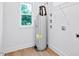 Utility room features a modern water heater, storage shelves, and a window with natural light at 0 Cedar Grove Church Rd Rd, Roxboro, NC 27574