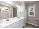 Double vanity bathroom with white cabinets and shower at 0 Theresia Ln, Roxboro, NC 27574