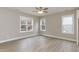Spacious bedroom with hardwood floors, ceiling fan, and multiple windows at 0 Theresia Ln, Roxboro, NC 27574
