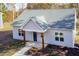 Newly constructed light gray house with a dark blue front door and wood-toned columns at 0 Theresia Ln, Roxboro, NC 27574