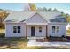 Newly constructed light gray house with a dark blue front door and wood-toned columns at 0 Theresia Ln, Roxboro, NC 27574