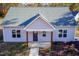 Newly constructed light gray house with a dark blue front door and wood-toned columns at 0 Theresia Ln, Roxboro, NC 27574