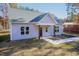 Newly constructed light gray house with a dark blue front door and wood-toned columns at 0 Theresia Ln, Roxboro, NC 27574