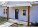 Newly constructed home's front entrance with a dark blue door and wood columns at 0 Theresia Ln, Roxboro, NC 27574