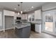 Modern kitchen with gray island, white cabinets, and backyard access at 0 Theresia Ln, Roxboro, NC 27574