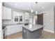 Modern kitchen with gray island, white cabinets, and barn door at 0 Theresia Ln, Roxboro, NC 27574