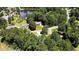 Aerial view of homes nestled amongst trees and a pond, showcasing the neighborhood's beautiful scenery at 1000 W Landing Dr, Sanford, NC 27330