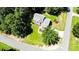 Aerial view of a home surrounded by lush greenery and a well-manicured lawn at 1000 W Landing Dr, Sanford, NC 27330