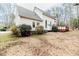 Expansive backyard featuring mature trees, a well-maintained lawn, and a charming back deck at 1000 W Landing Dr, Sanford, NC 27330