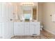 Bathroom with a double sink vanity with cabinets, a large mirror, and a toilet at 1000 W Landing Dr, Sanford, NC 27330