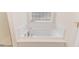 Jetted bathtub with tile surround and window at 1000 W Landing Dr, Sanford, NC 27330