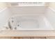 Jetted bathtub with tile surround and window at 1000 W Landing Dr, Sanford, NC 27330