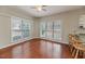 A dining area with hardwood floors, complemented by three windows, and a ceiling fan for added comfort at 1000 W Landing Dr, Sanford, NC 27330