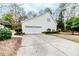 Home exterior with a two-car garage and concrete driveway surrounded by landscaped greenery at 1000 W Landing Dr, Sanford, NC 27330