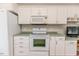 The kitchen features modern white appliances, white cabinets and ample counter space for cooking at 1000 W Landing Dr, Sanford, NC 27330