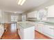 Bright kitchen with an island, white cabinets, and opens to a dining area with lots of natural light at 1000 W Landing Dr, Sanford, NC 27330