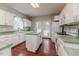 A well-equipped kitchen with white cabinets, an island, and a cozy view to the backyard at 1000 W Landing Dr, Sanford, NC 27330