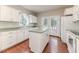Well-lit kitchen featuring white cabinets, modern appliances, and direct access to the backyard at 1000 W Landing Dr, Sanford, NC 27330