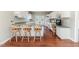 Bright kitchen featuring a breakfast bar with seating, white cabinets, and a view of the backyard at 1000 W Landing Dr, Sanford, NC 27330