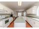 Bright kitchen with an island, white cabinets, and opens to a dining area with lots of natural light at 1000 W Landing Dr, Sanford, NC 27330