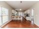 The kitchen features hardwood floors, white cabinets, and a breakfast bar with seating for casual dining at 1000 W Landing Dr, Sanford, NC 27330