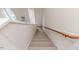 Carpeted staircase with a wooden handrail leading to the upper floor at 1000 W Landing Dr, Sanford, NC 27330