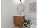 Cozy powder room featuring a modern vanity with a round mirror and stylish decor at 110 Continental Dr, Durham, NC 27712