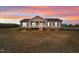Ranch style home with front porch and landscaped yard at 117 Hinshaw Shop Rd, Liberty, NC 27298