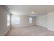 Spacious bedroom featuring neutral walls, carpet floors, and natural light from multiple windows at 120 Anise Tree Way, Clayton, NC 27527