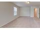 Cozy bedroom with carpet flooring, a large window, and a doorway, providing a comfortable living space at 120 Anise Tree Way, Clayton, NC 27527