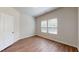 Bright bedroom featuring hardwood floors, natural light and a door at 120 Anise Tree Way, Clayton, NC 27527