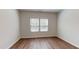 Cozy bedroom with neutral walls, two windows for natural light and hardwood floors at 120 Anise Tree Way, Clayton, NC 27527