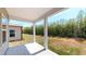 Covered patio with white pillars offers relaxing outdoor views and shade at 120 Anise Tree Way, Clayton, NC 27527