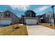 Charming two-story home featuring stone accents, a two-car garage, and a well-manicured front lawn at 120 Anise Tree Way, Clayton, NC 27527