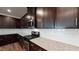 Modern kitchen boasts stainless steel appliances, granite countertops, dark cabinetry and a convenient kitchen island at 120 Anise Tree Way, Clayton, NC 27527