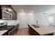 Modern kitchen boasts stainless steel appliances, granite countertops, dark cabinetry and a convenient kitchen island at 120 Anise Tree Way, Clayton, NC 27527