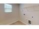 Well-lit laundry room with tile flooring, essential hookups and services plus shelving for detergents at 120 Anise Tree Way, Clayton, NC 27527