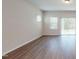 Spacious living room boasts hardwood floors, natural light, and sliding door access to the outdoors at 120 Anise Tree Way, Clayton, NC 27527