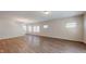 Bright and airy living room featuring hardwood floors and natural light from multiple windows at 120 Anise Tree Way, Clayton, NC 27527