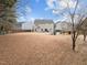 Large backyard featuring a grassy area, playground, and plenty of space for recreation at 12420 Tetons Ct, Durham, NC 27703