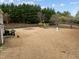 Expansive backyard featuring mature trees, a play set, and grill at 12420 Tetons Ct, Durham, NC 27703