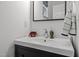 Modern bathroom with a white sink, black vanity, and decorative accents at 12420 Tetons Ct, Durham, NC 27703