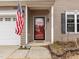 Close-up of the front door with an American flag and clean entryway at 12420 Tetons Ct, Durham, NC 27703