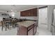 Kitchen area features a center island, stainless appliances, granite counters, and tile flooring at 12420 Tetons Ct, Durham, NC 27703