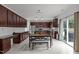 Spacious kitchen features modern appliances, dining table, and sliding doors to the outside at 12420 Tetons Ct, Durham, NC 27703