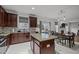 Kitchen area with a large island, granite counters, stainless appliances, and an adjacent dining area at 12420 Tetons Ct, Durham, NC 27703
