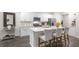 Modern kitchen with island, stainless steel appliances, and white cabinetry at 1316 White Verona Way, Knightdale, NC 27545