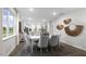 Bright dining room with a white table and grey chairs at 1320 White Verona Way, Knightdale, NC 27545
