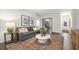 Cozy living room with grey sofa and a view into the home office at 1320 White Verona Way, Knightdale, NC 27545
